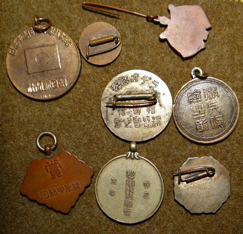 Eight Small Japanese Badges